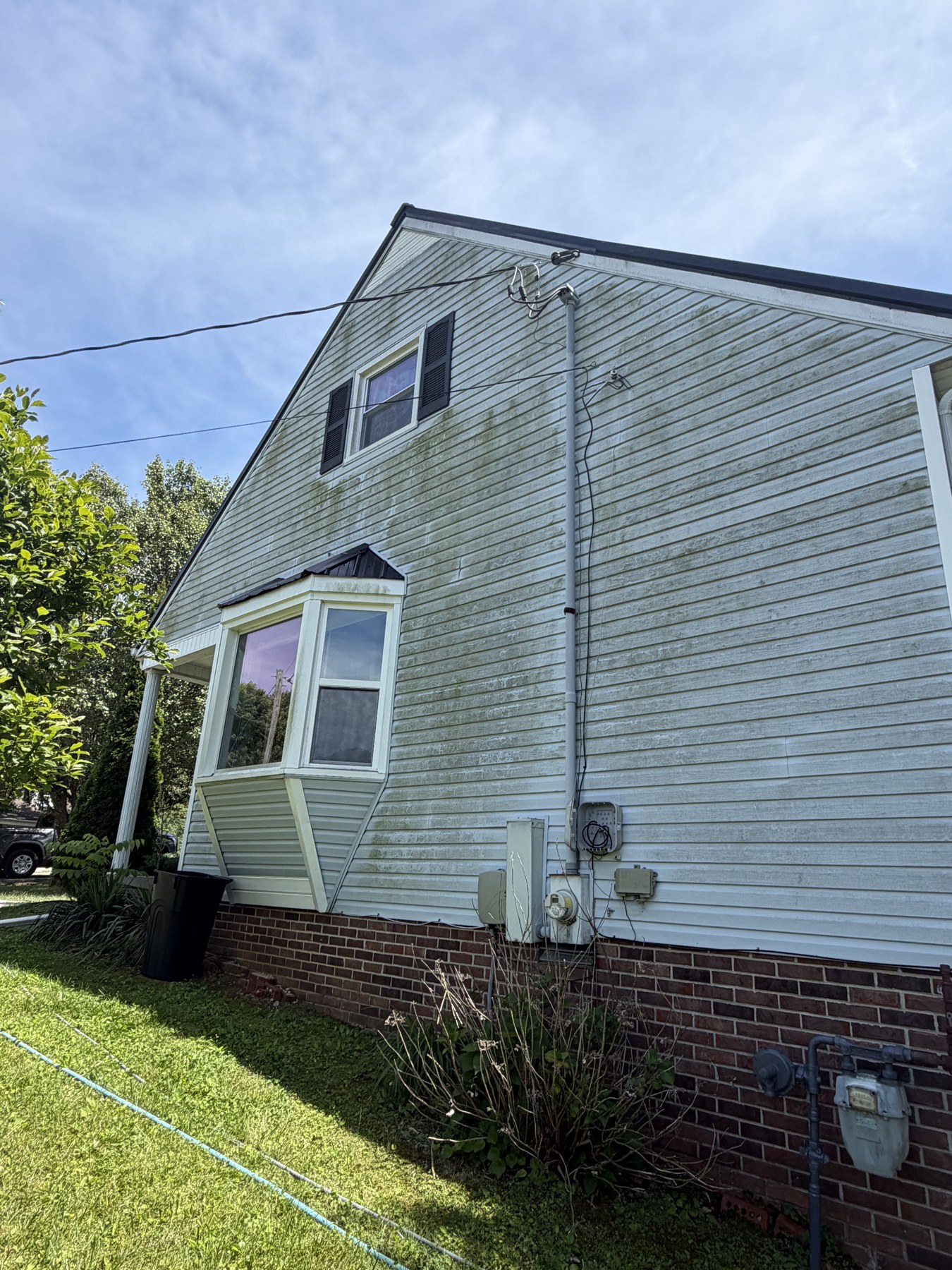 Dirty/algae-stained exterior before soft wash in Livingston, TN