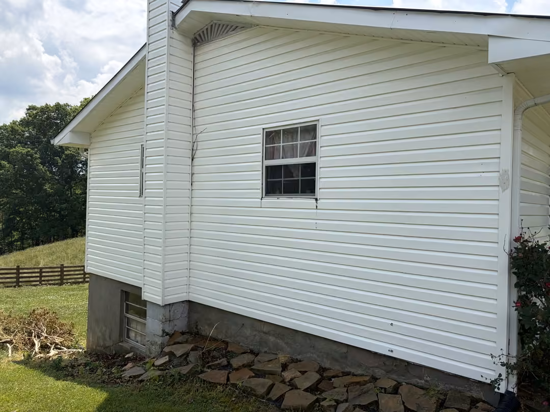 Clean white vinyl siding after house soft wash in Monterey, TN
