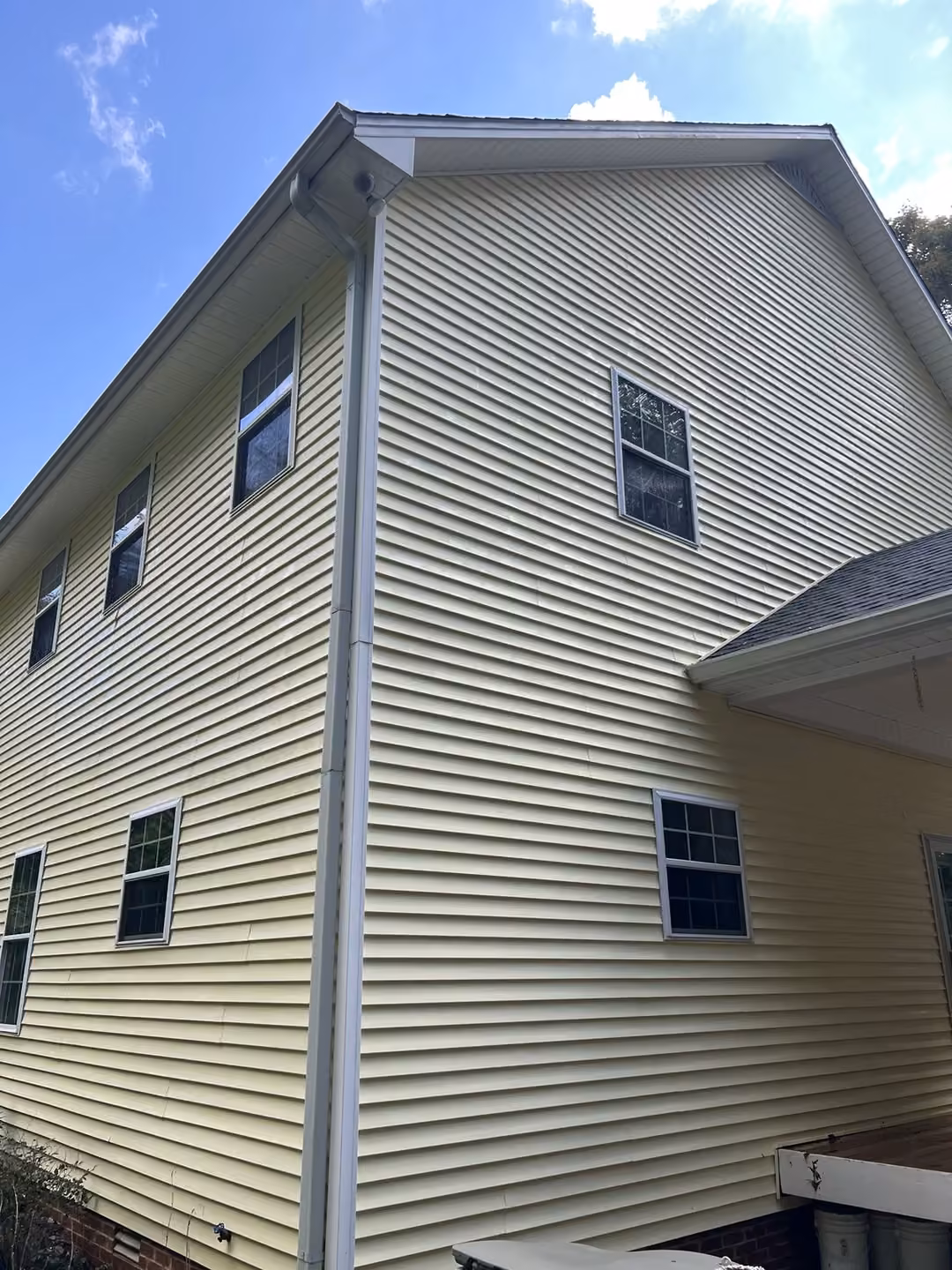Clean yellow siding after soft wash in Sparta, TN