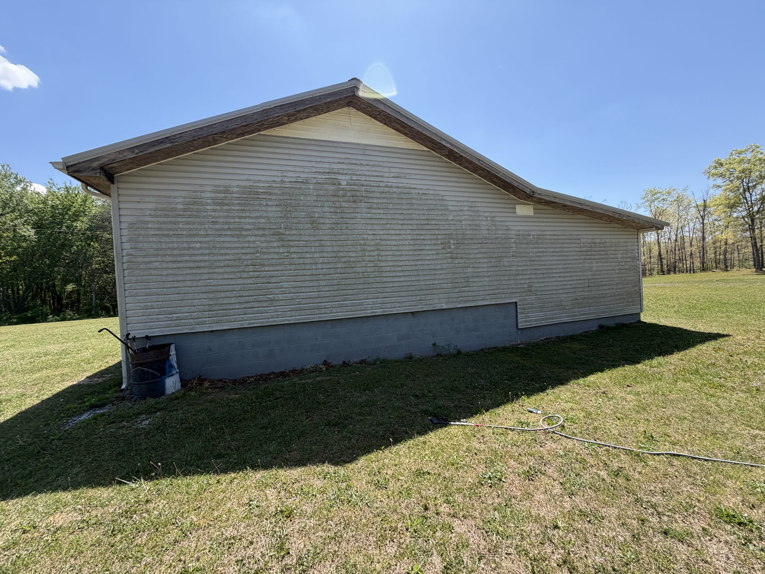 Dirty/algae-stained exterior before soft wash in Spencer, TN